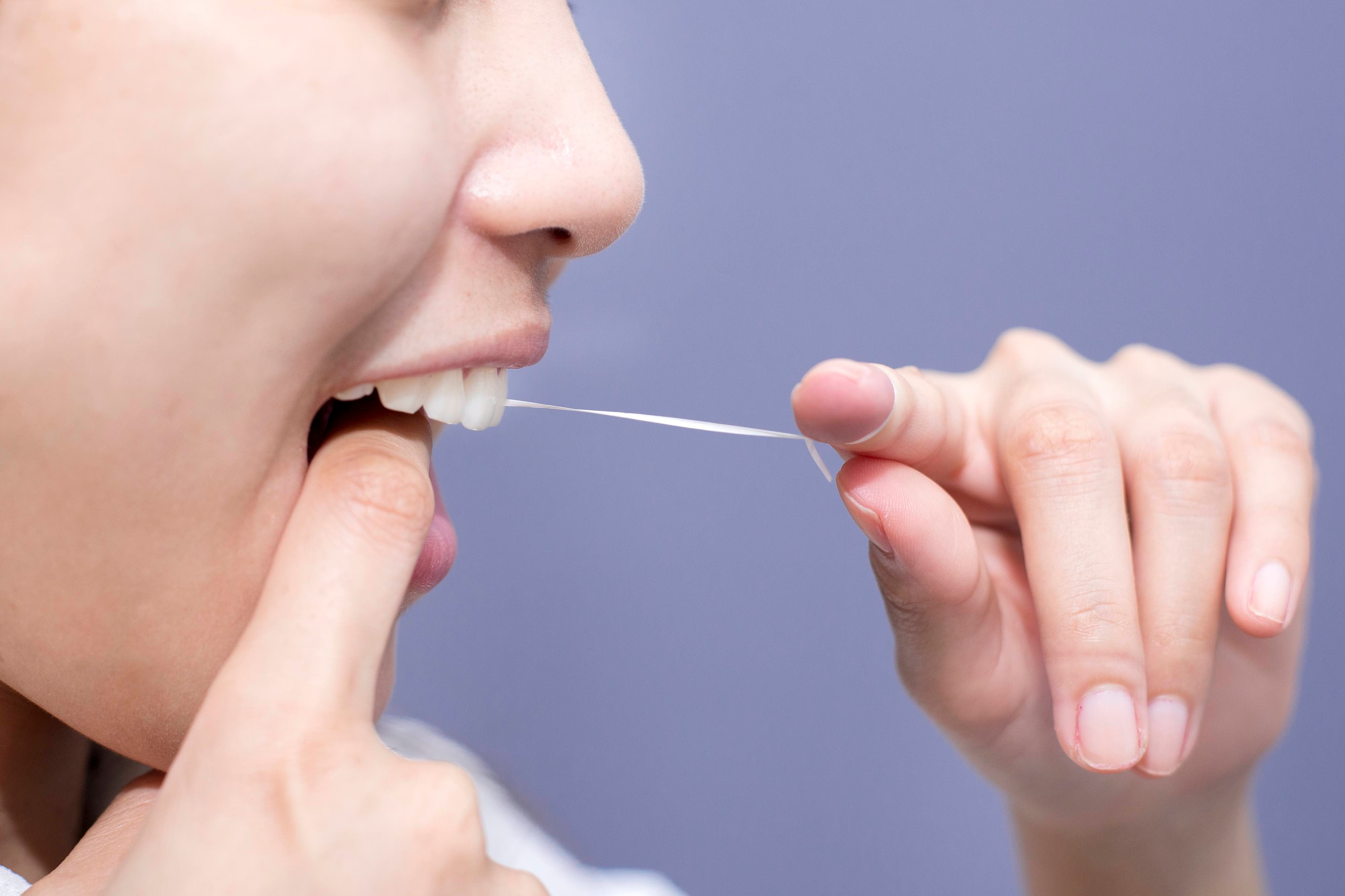 Flossing helps remove food particles and plaque from between our teeth and under our gumline